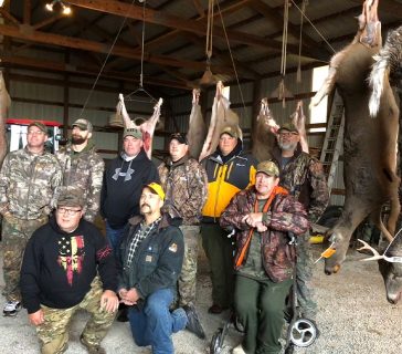 close up of the hunters in front of their bows they caught
